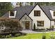 Charming front entrance with stone accents and a professionally landscaped yard at 1155 Peachtree Battle Nw Ave, Atlanta, GA 30327
