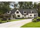 Charming home exterior featuring a manicured lawn and a concrete driveway at 1155 Peachtree Battle Nw Ave, Atlanta, GA 30327
