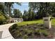 A beautiful traditional home exterior with an expansive lawn and mature trees at 1155 Peachtree Battle Nw Ave, Atlanta, GA 30327