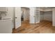 Hallway featuring an open doorway to a bonus room and doorway to a storage area at 1155 Peachtree Battle Nw Ave, Atlanta, GA 30327