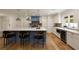 An open layout kitchen featuring white cabinets, a blue kitchen island, and stainless steel appliances at 1155 Peachtree Battle Nw Ave, Atlanta, GA 30327