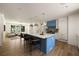 Bright kitchen featuring a large island, stainless steel pendant lights, and an open layout to the living room at 1155 Peachtree Battle Nw Ave, Atlanta, GA 30327