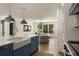 Kitchen with large island, stainless steel appliances, white cabinets, and view into the living room at 1155 Peachtree Battle Nw Ave, Atlanta, GA 30327