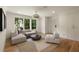 Bright living room with large windows, hardwood floors, neutral furniture, and modern lighting at 1155 Peachtree Battle Nw Ave, Atlanta, GA 30327
