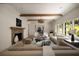 Bright living room featuring wood beams, fireplace, and beautiful hardwood floors at 1155 Peachtree Battle Nw Ave, Atlanta, GA 30327