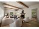 Spacious living room featuring hardwood floors, wood beams, fireplace and abundant natural light at 1155 Peachtree Battle Nw Ave, Atlanta, GA 30327
