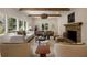 Comfortable living room with wood beams, fireplace and several windows offering lots of natural light at 1155 Peachtree Battle Nw Ave, Atlanta, GA 30327