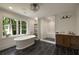 Luxurious main bathroom with a standalone tub, glass enclosed shower and natural lighting at 1155 Peachtree Battle Nw Ave, Atlanta, GA 30327