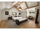 Bright main bedroom featuring a king bed, sitting area, and exposed beam vaulted ceilings at 1155 Peachtree Battle Nw Ave, Atlanta, GA 30327