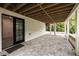 Covered outdoor patio with paver flooring and backyard access at 1155 Peachtree Battle Nw Ave, Atlanta, GA 30327