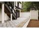 A beautiful stone patio features a stairwell and double doors leading into the home at 1155 Peachtree Battle Nw Ave, Atlanta, GA 30327