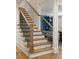 Staircase featuring wood steps and black metal railings at 1155 Peachtree Battle Nw Ave, Atlanta, GA 30327