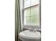 Close up on bathroom featuring subway tile, pedestal sink, and frosted window at 737 Barnett Ne St # B6, Atlanta, GA 30306