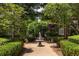 Brick building featuring mature trees, manicured hedges, and fountain at 737 Barnett Ne St # B6, Atlanta, GA 30306