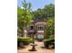 Brick exterior of 'The Barnett' features a charming fountain and manicured landscaping at 737 Barnett Ne St # B6, Atlanta, GA 30306