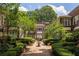 Beautiful brick exterior of 'The Barnett' with manicured courtyard, greenery and fountain at 737 Barnett Ne St # B6, Atlanta, GA 30306