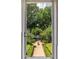 Window view of a manicured garden with mature trees and a central fountain at 737 Barnett Ne St # B6, Atlanta, GA 30306