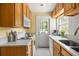 Cozy kitchen featuring white appliances, tile backsplash, and natural wood cabinetry at 737 Barnett Ne St # B6, Atlanta, GA 30306