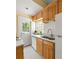 Bright kitchen features white appliances, wood cabinets, and a window over the sink at 737 Barnett Ne St # B6, Atlanta, GA 30306