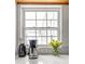 Close up of a kitchen window with countertop, coffeemaker, and fresh flowers at 737 Barnett Ne St # B6, Atlanta, GA 30306