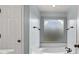Bright bathroom with a soaking tub and frosted window at 11 Chad Ct, Mcdonough, GA 30253