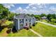 Two-story home boasts a manicured lawn, a red door, and mature trees surrounding the property at 11 Chad Ct, Mcdonough, GA 30253