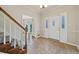 Bright foyer features tile flooring, a staircase, and a white front door with glass accents at 11 Chad Ct, Mcdonough, GA 30253