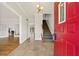 Inviting foyer with tile flooring, chandelier, staircase, and bright red front door at 11 Chad Ct, Mcdonough, GA 30253