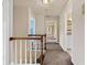 Upstairs hallway with carpet and wooden railing at 11 Chad Ct, Mcdonough, GA 30253