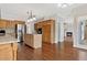 Traditional kitchen with stainless steel appliances, an island, and rich wood cabinetry with access to living room at 11 Chad Ct, Mcdonough, GA 30253