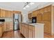 Traditional-style kitchen with wooden cabinets, stainless steel appliances, and a functional center island at 11 Chad Ct, Mcdonough, GA 30253