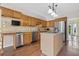 Bright kitchen featuring stainless steel appliances, granite countertops, an island, and wood-style floors at 11 Chad Ct, Mcdonough, GA 30253