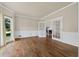 Spacious living room features hardwood floors, french doors, and a sun-filled window at 11 Chad Ct, Mcdonough, GA 30253
