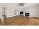 Spacious living room with hardwood floors, fireplace, and open access to other rooms at 11 Chad Ct, Mcdonough, GA 30253