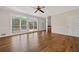 Bright living room features hardwood flooring, three large windows, and backyard pool view at 11 Chad Ct, Mcdonough, GA 30253
