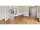 Open floor plan with hardwood floors, white trim, and views into an adjacent sunroom at 11 Chad Ct, Mcdonough, GA 30253