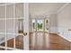 Bright room features hardwood flooring, white trim, and a bay window overlooking the front yard at 11 Chad Ct, Mcdonough, GA 30253