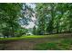 Large backyard space with mature trees provides ample room for outdoor activities and serene views of the property at 261 Clayton Trl, Canton, GA 30114