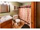 Functional bathroom with vanity, mirrored cabinet, and shower with curtain at 261 Clayton Trl, Canton, GA 30114