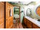 Bathroom with dual sinks, wood cabinets, and a separate tub room at 261 Clayton Trl, Canton, GA 30114