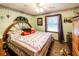 Charming bedroom with unique headboard, ceiling fan, and patterned bedding at 261 Clayton Trl, Canton, GA 30114
