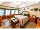 Cozy bedroom with ample natural light, wood flooring, and decorative headboard at 261 Clayton Trl, Canton, GA 30114
