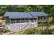 Exterior of a house with gray siding, dark roof and covered front porch at 261 Clayton Trl, Canton, GA 30114