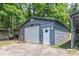 Exterior of a gray building with white roll up door and covered extension at 261 Clayton Trl, Canton, GA 30114