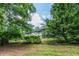 Charming home with a covered porch and lush green surroundings offers a serene and inviting curb appeal at 261 Clayton Trl, Canton, GA 30114