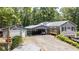 A side exterior view shows a carport, shed, and a deck with wooded area at 261 Clayton Trl, Canton, GA 30114
