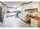 The full kitchen features a stainless steel refrigerator, white cabinets, and a skylight at 261 Clayton Trl, Canton, GA 30114