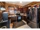Rustic kitchen features wood walls, updated appliances, and wood cabinets at 261 Clayton Trl, Canton, GA 30114
