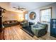Cozy living room with comfortable seating, wood flooring, and large windows at 261 Clayton Trl, Canton, GA 30114