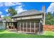 A home featuring a screened porch, covered patio, lush lawn, and fenced yard, perfect for relaxation and privacy at 3117 Blowing Wind Nw Ct, Acworth, GA 30101